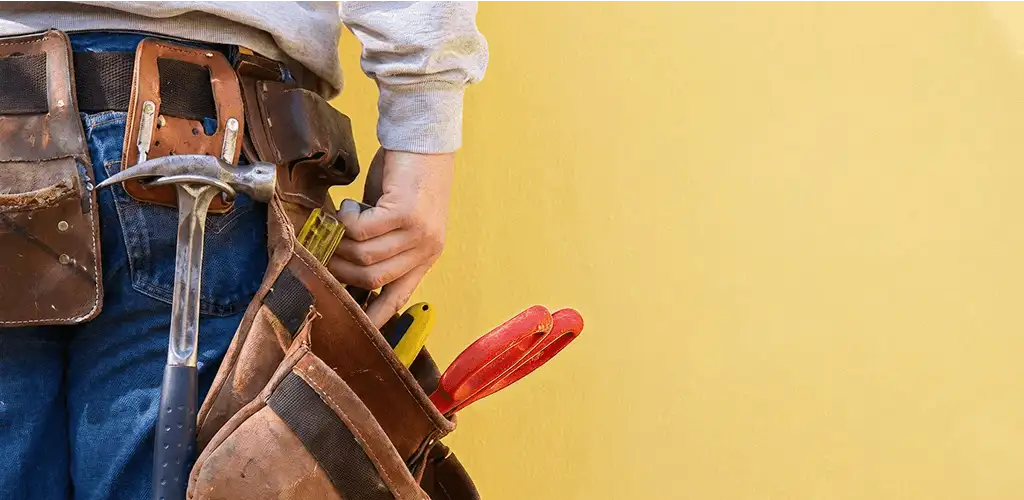 Handyman with tool belt ready for home repairs and maintenance in Phoenix, AZ