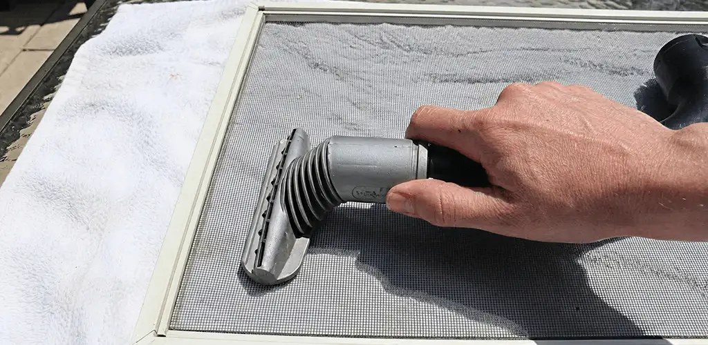Window screen repair cleaning and fixing a damaged screen mesh in Phoenix, AZ